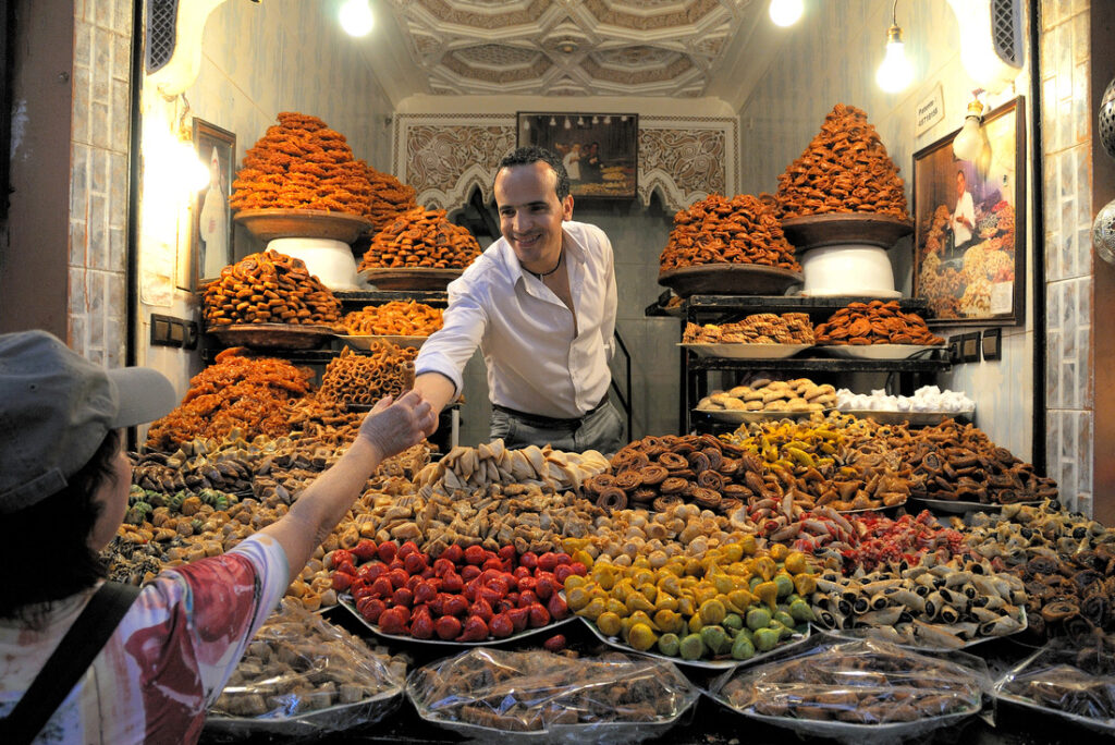 Woman shopping in Marrakech, Morocco and practicing haggling